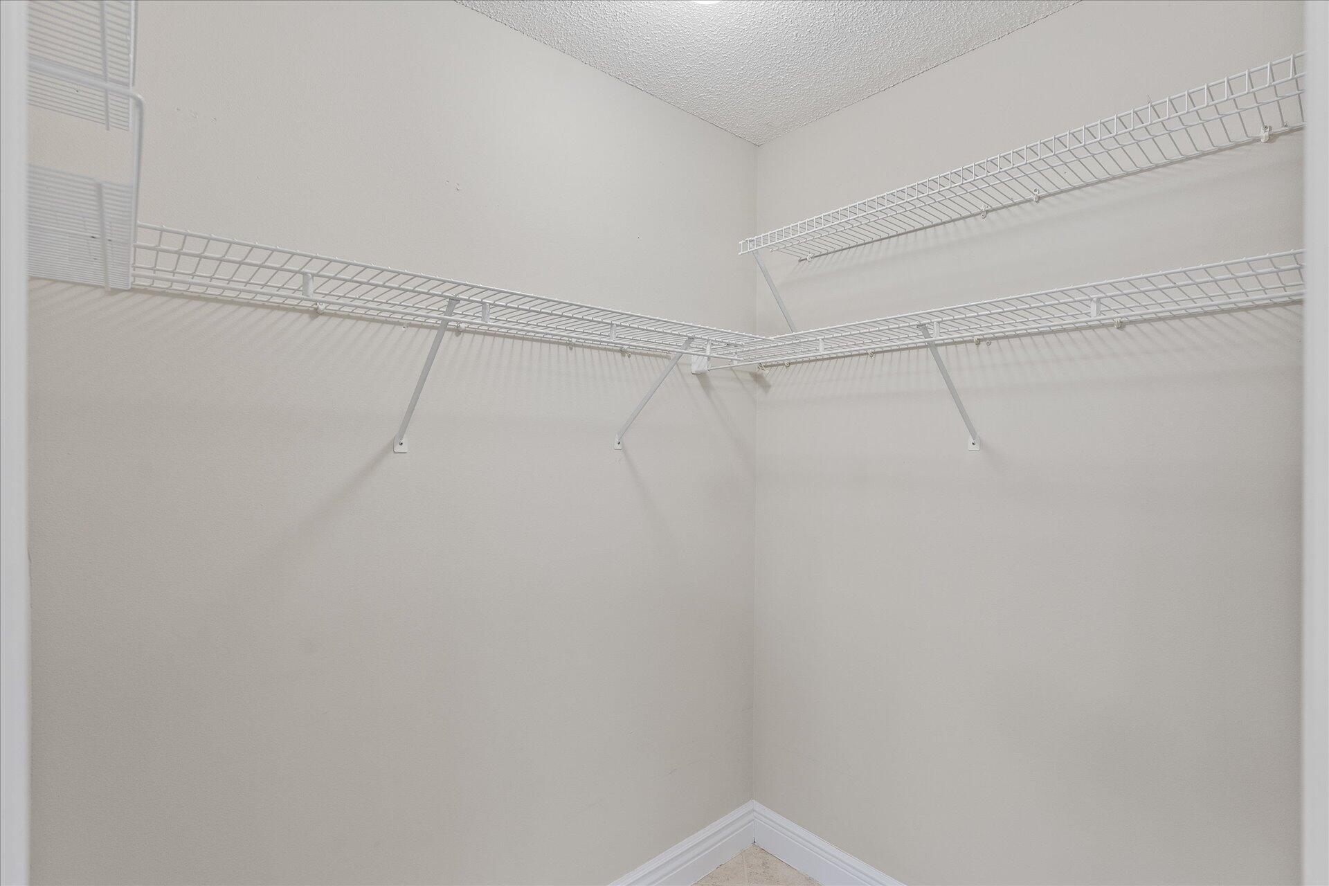 2723 Rambler Court Navarre, FL 32566 - Photo 26 of 40 a view of a room with racks on the wall