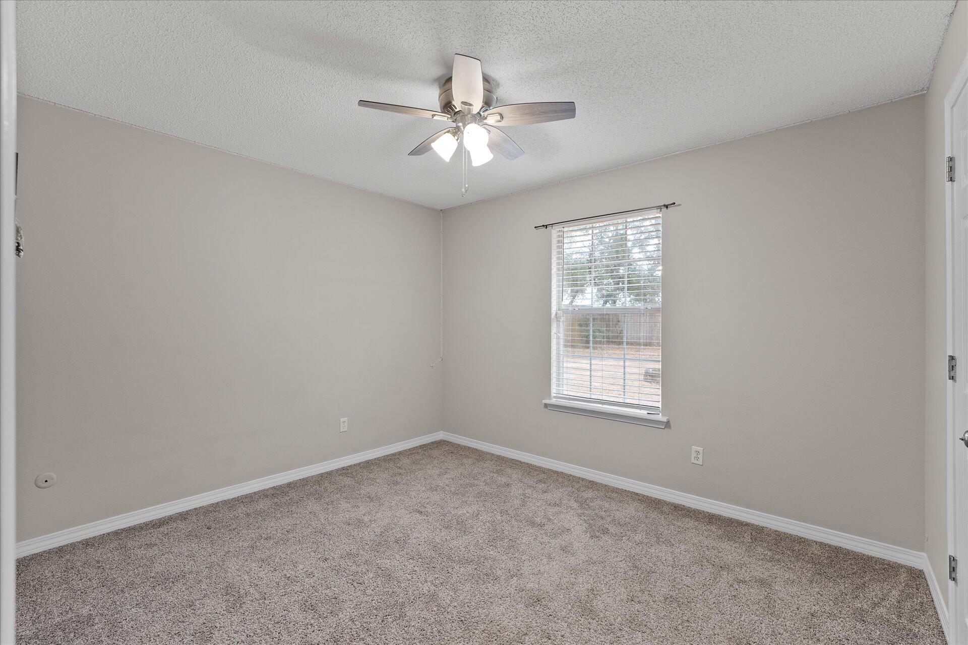 2723 Rambler Court Navarre, FL 32566 - Photo 30 of 40 an empty room with a window and a fan