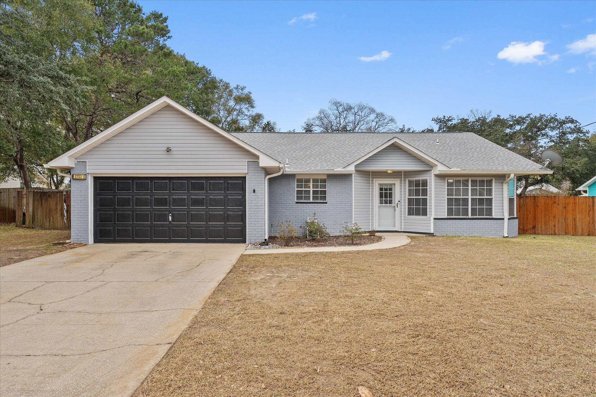 2723 Rambler Court Navarre, FL 32566 - Photo 3 of 40 a front view of a house with yard and parking