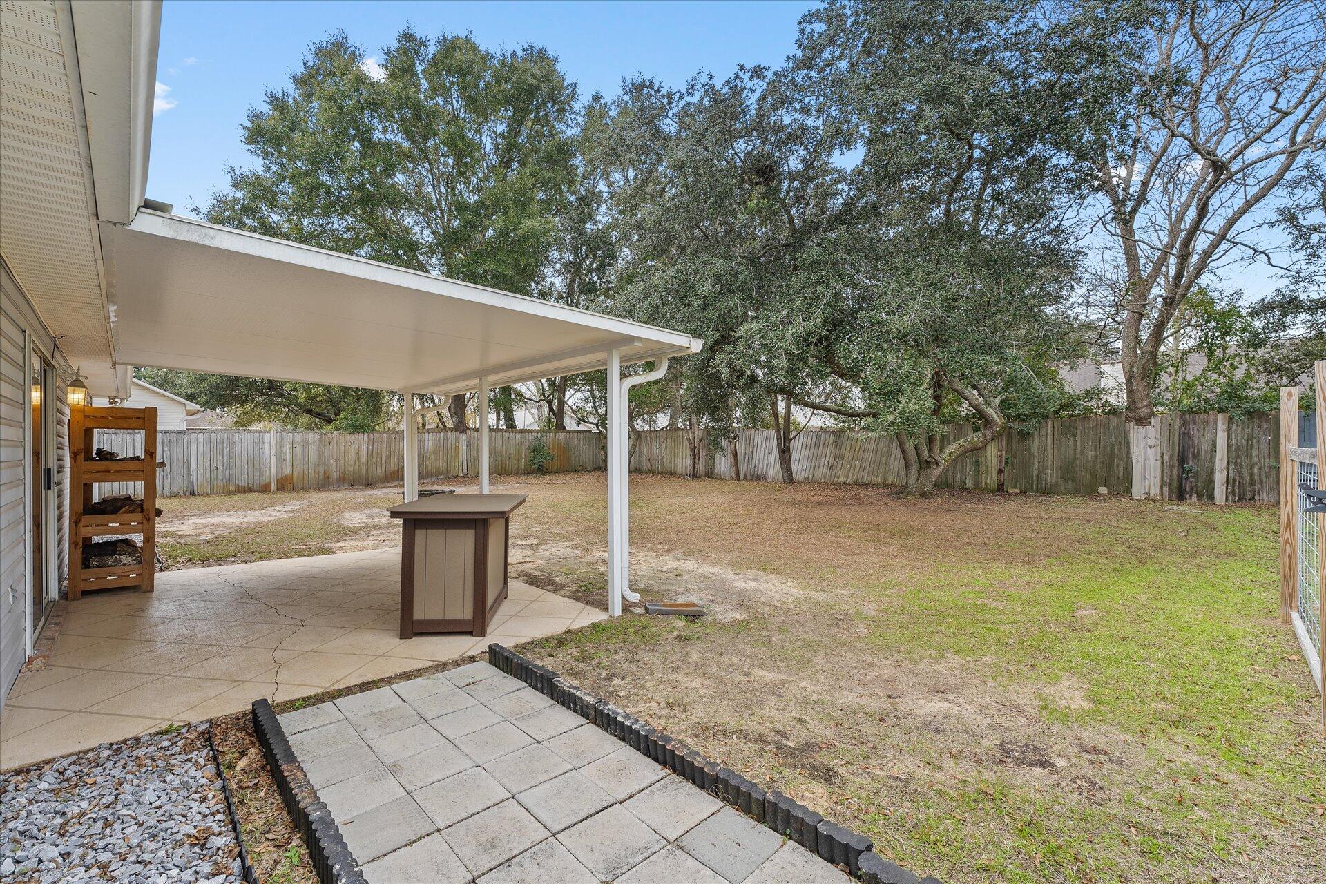 2723 Rambler Court Navarre, FL 32566 - Photo 35 of 40 a view of a backyard with sitting area