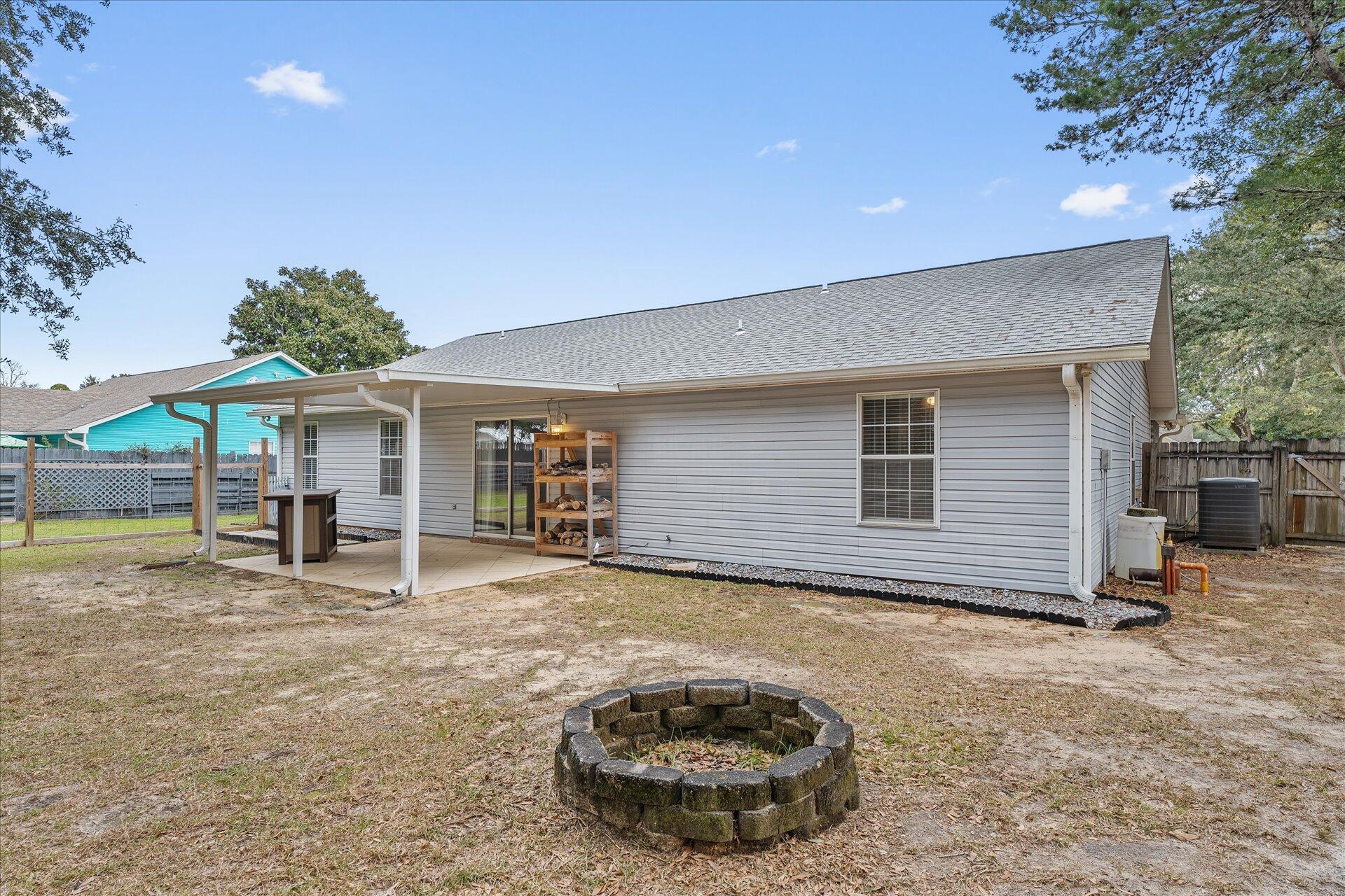 2723 Rambler Court Navarre, FL 32566 - Photo 36 of 40 a view of a house with backyard and sitting area