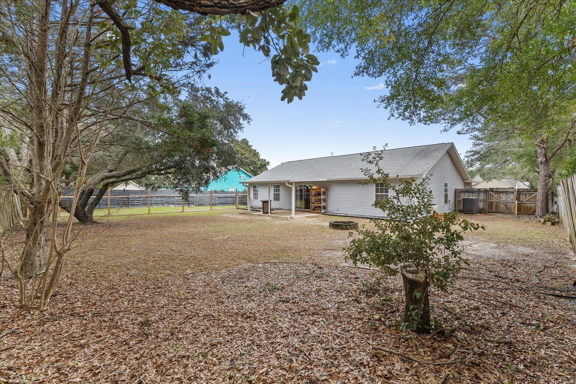 2723 Rambler Court Navarre, FL 32566 - Photo 38 of 40 a front view of a house with a yard and garage