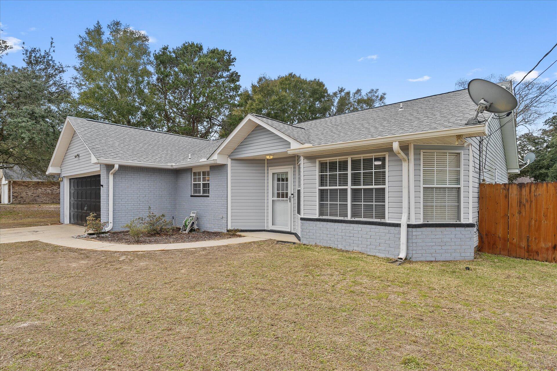 2723 Rambler Court Navarre, FL 32566 - Photo 4 of 40 a front view of a house with garden
