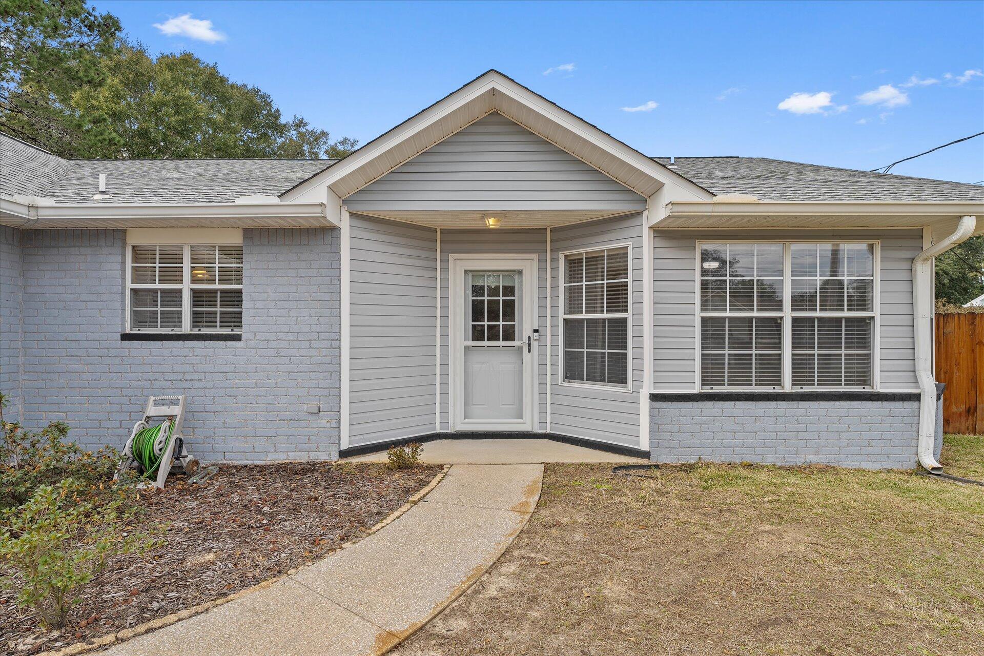 2723 Rambler Court Navarre, FL 32566 - Photo 5 of 40 a front view of a house having yard