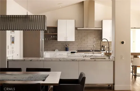 a kitchen with a sink a refrigerator and cabinets