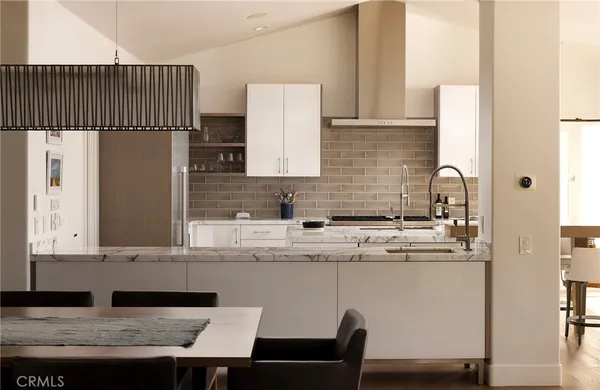 a kitchen with a sink a refrigerator and cabinets