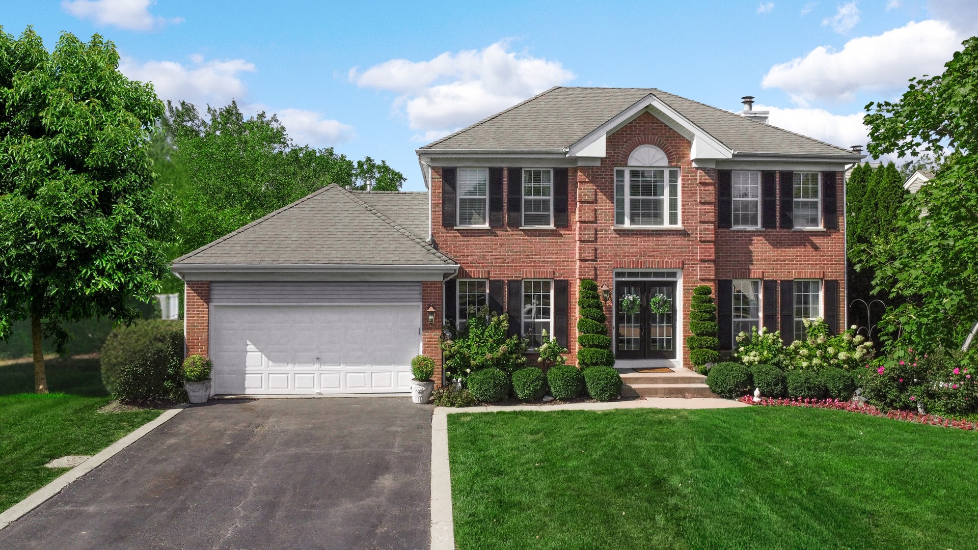 9209 Jasmine Way Fox River Grove, IL 60021 - Photo 1 of 37 a front view of a house with a yard and trees