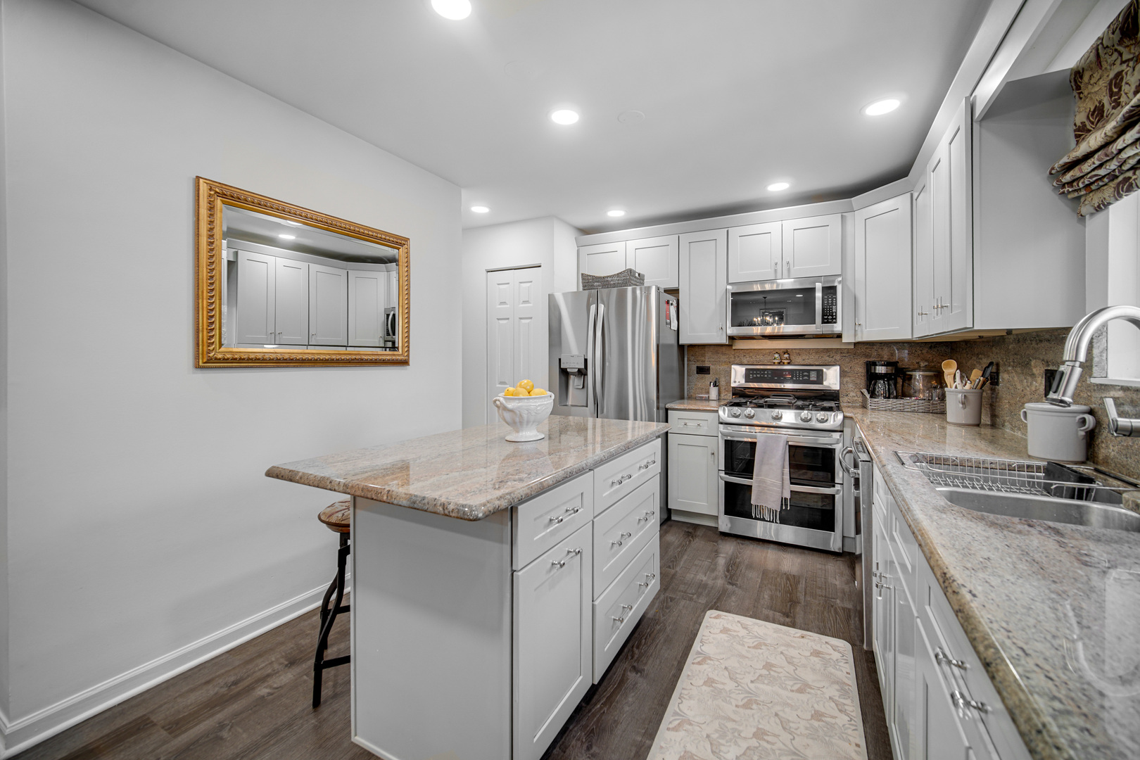 9209 Jasmine Way Fox River Grove, IL 60021 - Photo 11 of 37 a kitchen with kitchen island granite countertop stainless steel appliances cabinets a sink and a counter top space