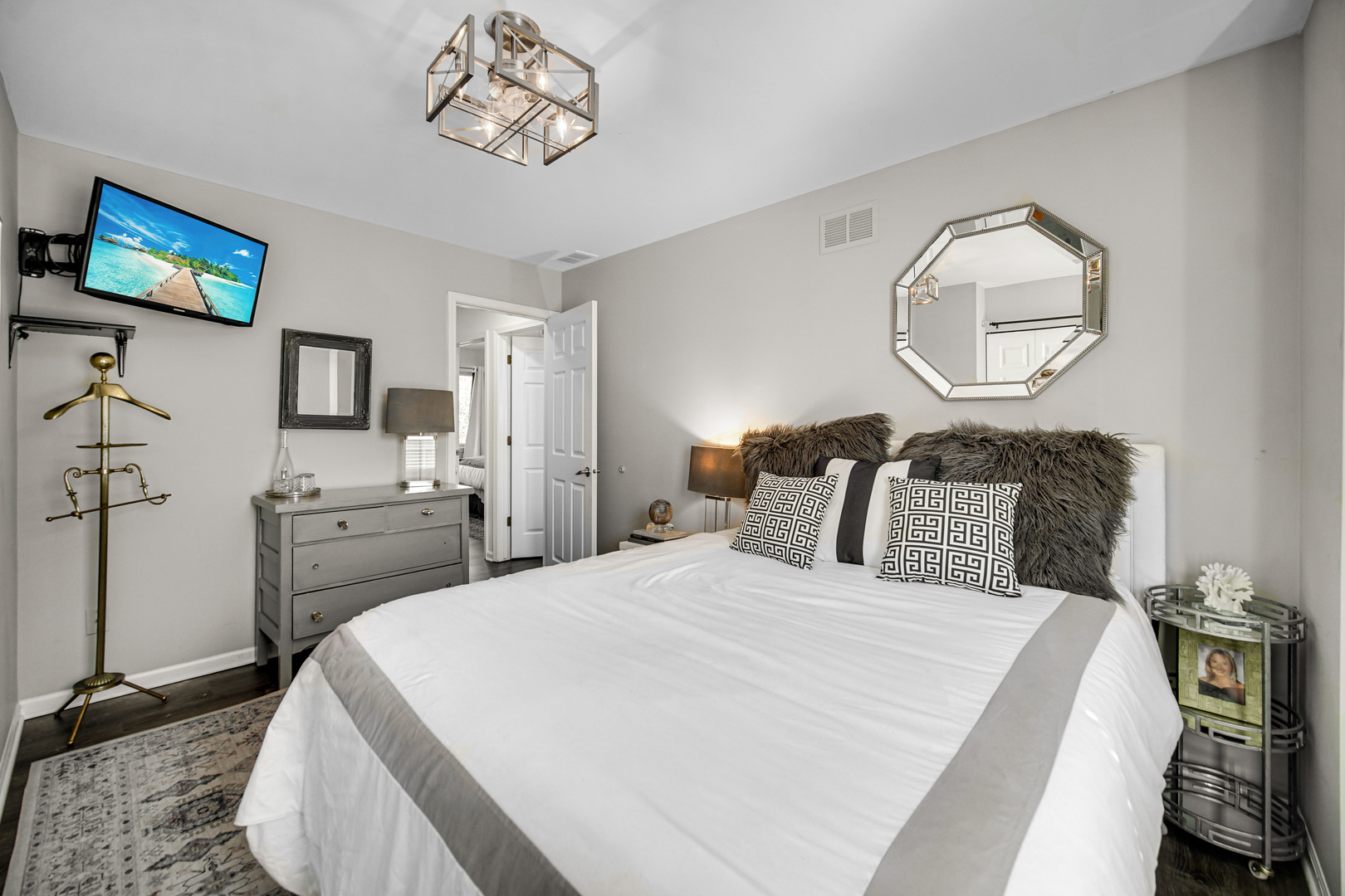 9209 Jasmine Way Fox River Grove, IL 60021 - Photo 18 of 37 a bedroom with a bed and a chandelier
