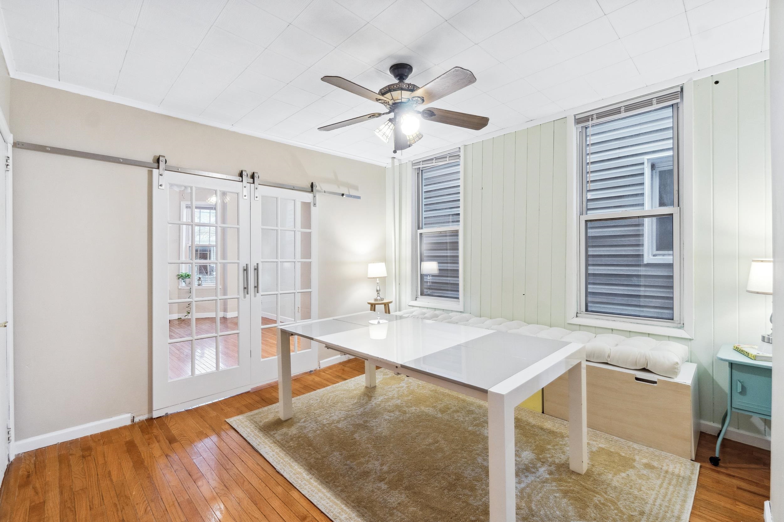 223 Dodd Street, Unit 1 Weehawken, NJ 07086 - Photo 11 of 28 a workspace with wooden floor and windows