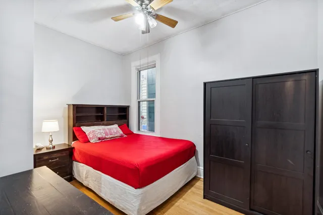 a kitchen with a refrigerator a stove a sink dishwasher and a dining table with wooden floor