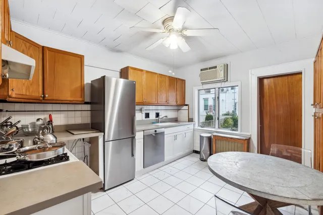 a kitchen with stainless steel appliances granite countertop a stove refrigerator sink and cabinets