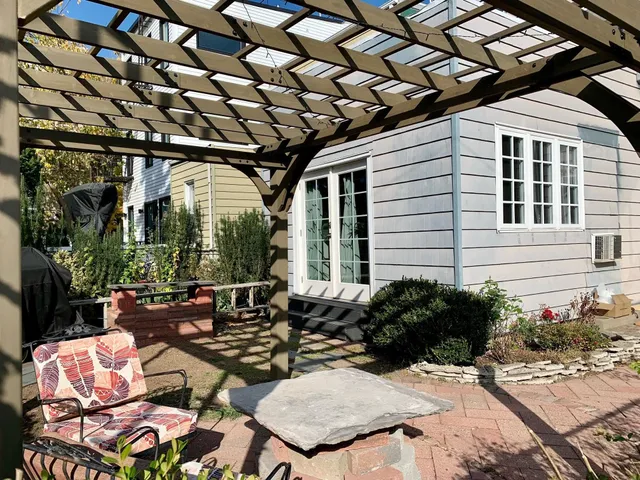 a view of a chairs and table in the patio and a fountain in the patio