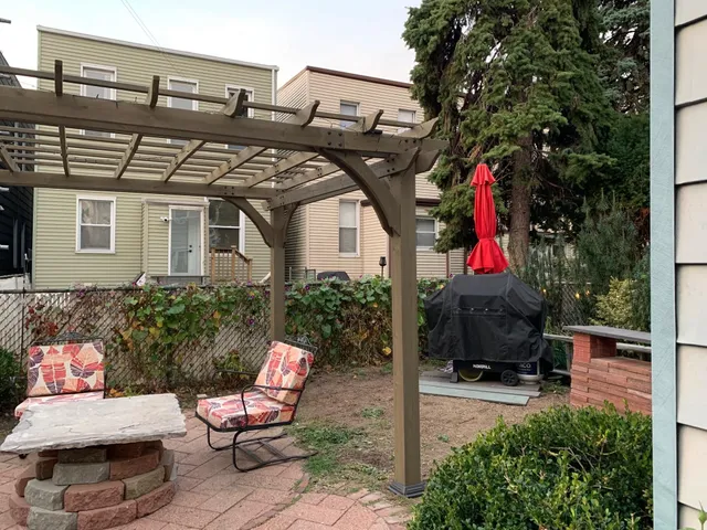 a view of a chairs and table in the patio and a fountain in the patio