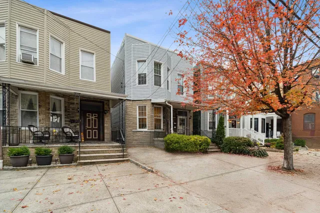 front view of a brick house with a yard