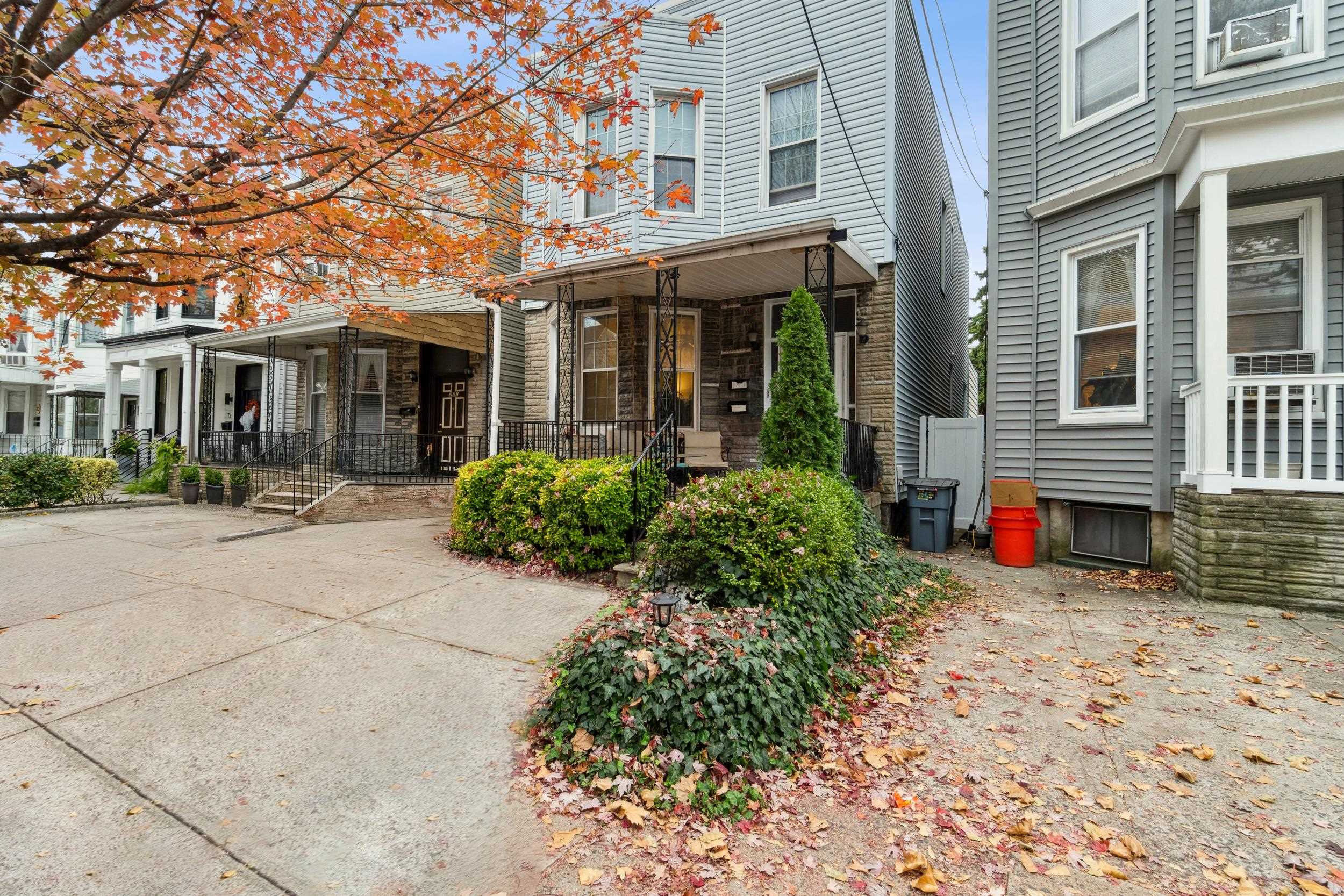 223 Dodd Street, Unit 1 Weehawken, NJ 07086 - Photo 26 of 28 front view of a brick house with a yard