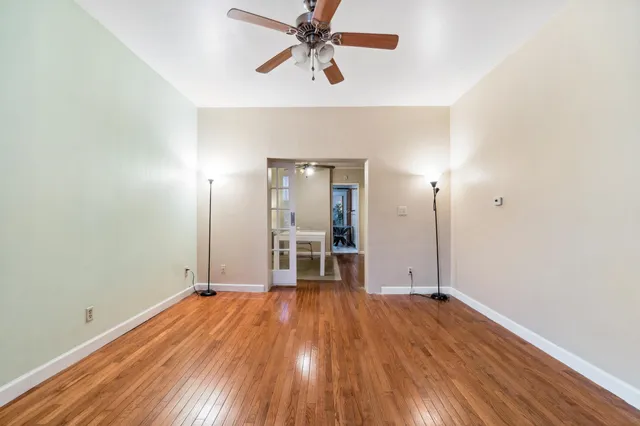 a view of a livingroom with a chandelier fan