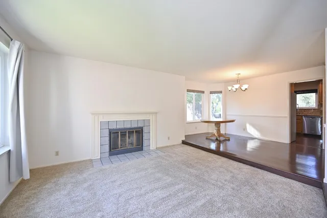 an empty room with furniture and a fireplace