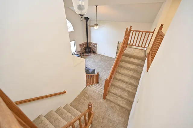 a view of an empty room with a ceiling fan and window