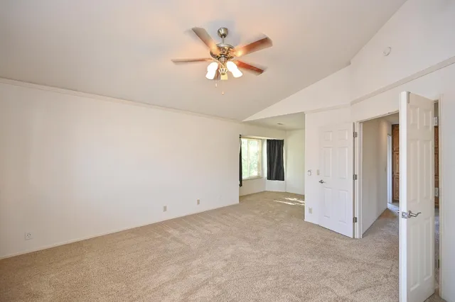a en suite bathroom with a granite countertop sink and a large mirror
