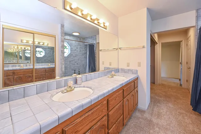 a bathroom with a sink a vanity and a mirror