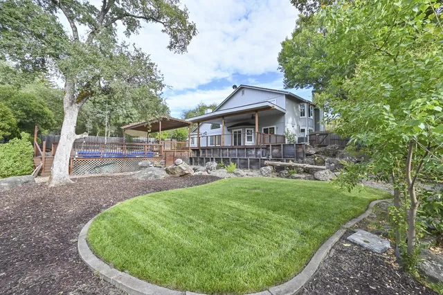 a view of a house with backyard porch and sitting area