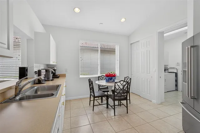 a bedroom with a bed and a flat tv screen on dresser