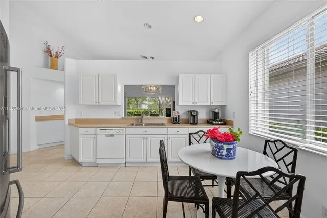 a spacious bathroom with a granite countertop sink a mirror and a shower