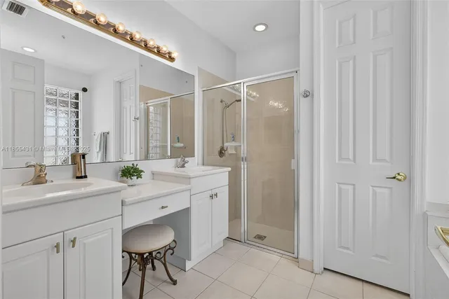 a spacious bathroom with a mirror a sink and a mirror
