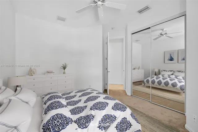 a view of a house with backyard and a tree