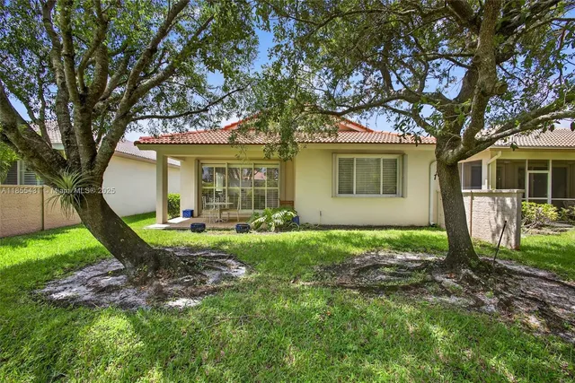 an aerial view of residential houses with outdoor space and street view