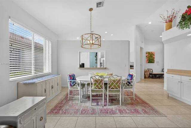 a kitchen with granite countertop a sink cabinets and stainless steel appliances