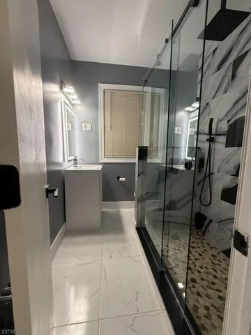 a large bathroom with a glass shower door