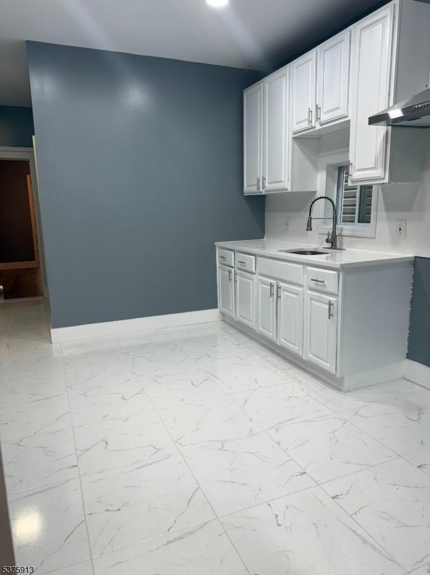 1059 Lafayette Street Elizabeth, NJ 07201 - Photo 8 of 10 a kitchen with granite countertop white cabinets and stainless steel appliances