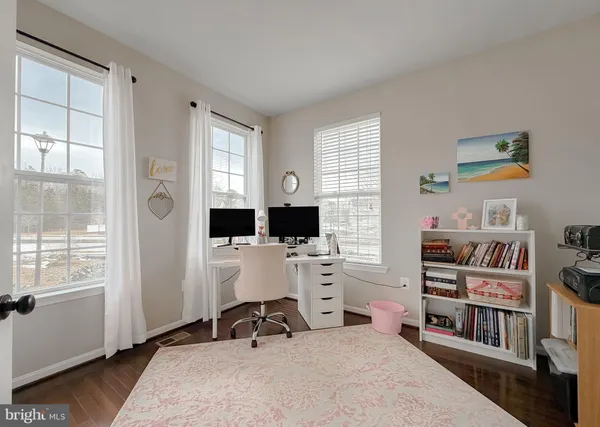 a room with furniture a bookshelf and a window