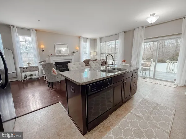 a kitchen with kitchen island granite countertop a sink counter and cabinets