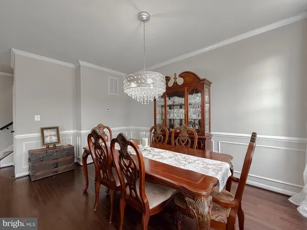 a view of a dining room with furniture wooden floor and chandelier