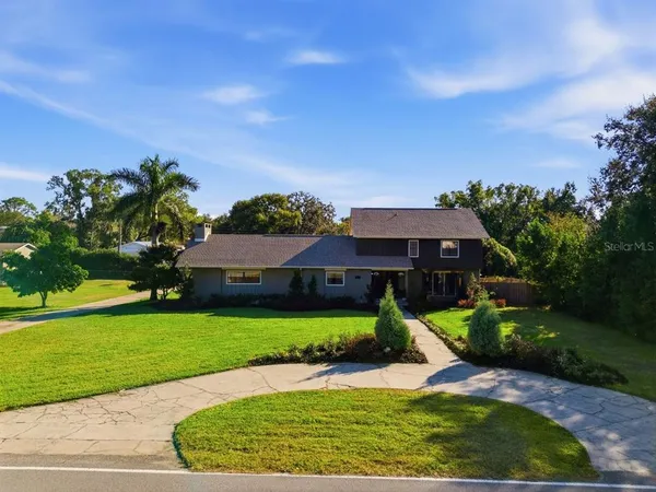 an aerial view of a house with garden space and patio