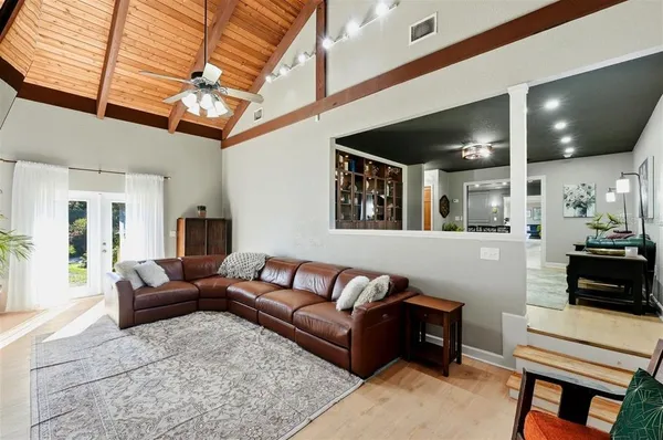 a bedroom with a large bed and a chandelier
