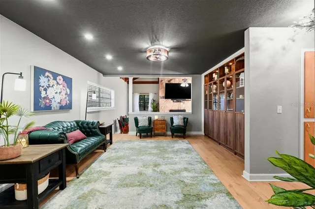 a bedroom with a large bed and a chandelier