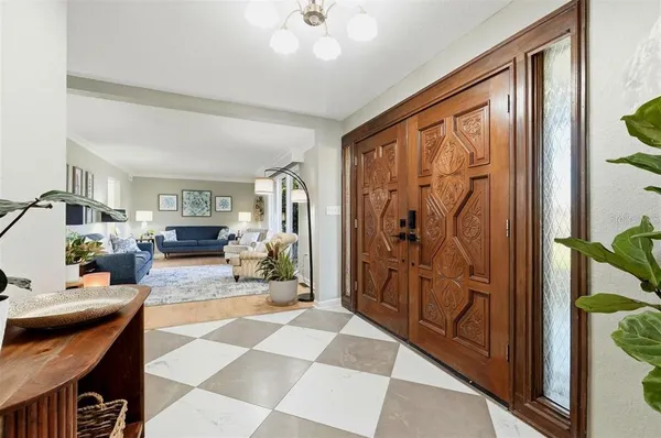 a living room with furniture potted plant and a mirror