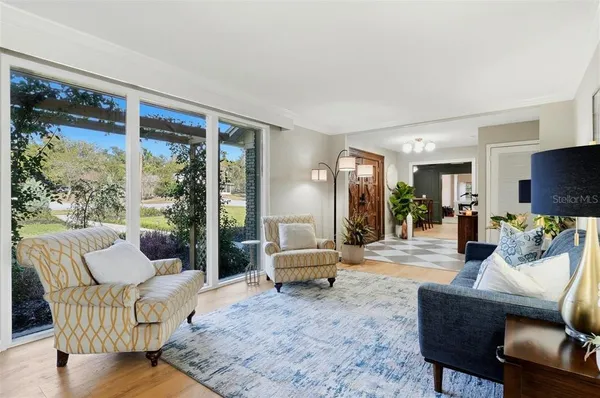 a living room with furniture and wooden floor