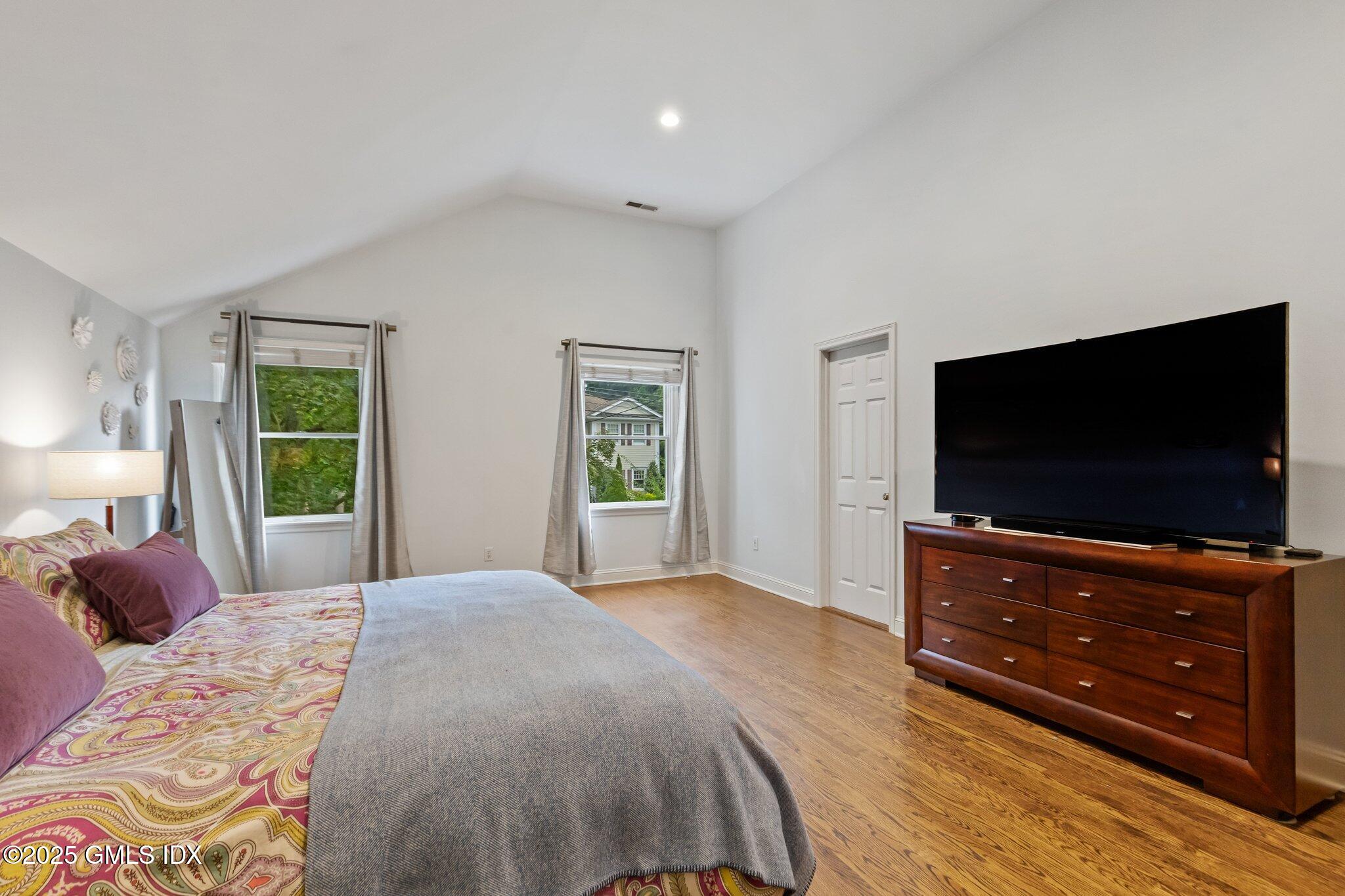 4 Tyler Lane Riverside, CT 06878 - Photo 17 of 27 a bedroom with a bed and a flat screen tv