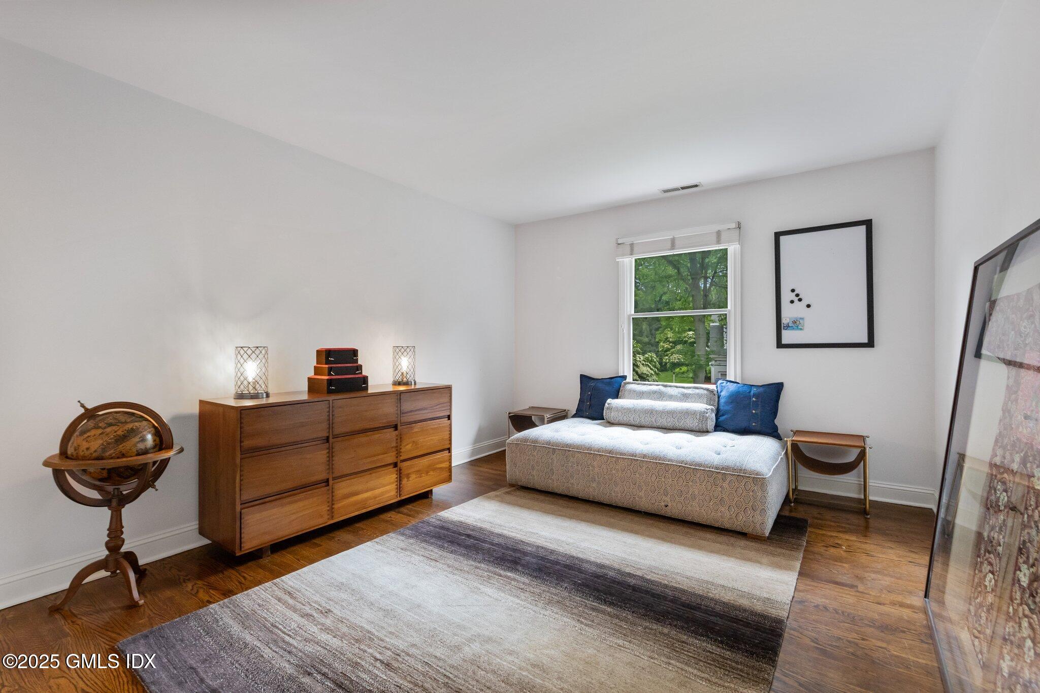 4 Tyler Lane Riverside, CT 06878 - Photo 19 of 27 a bedroom with a bed and a chandelier