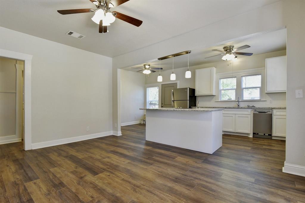 1115 South Rusk Avenue Denison, TX 75020 - Photo 7 of 21 a view of a kitchen with a sink stainless steel appliances and cabinets
