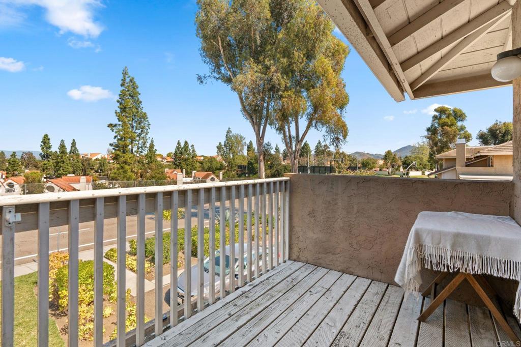 17597 Fairlie Road San Diego, CA 92128 - Photo 12 of 15 a view of a balcony with wooden chairs