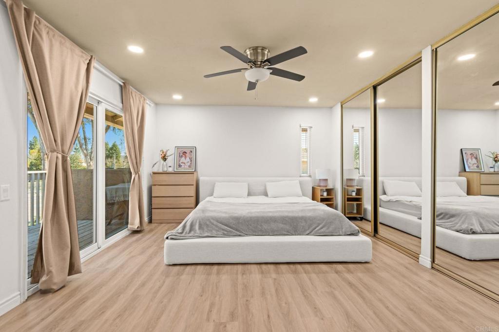 17597 Fairlie Road San Diego, CA 92128 - Photo 6 of 15 a spacious bedroom with a large bed and a chandelier