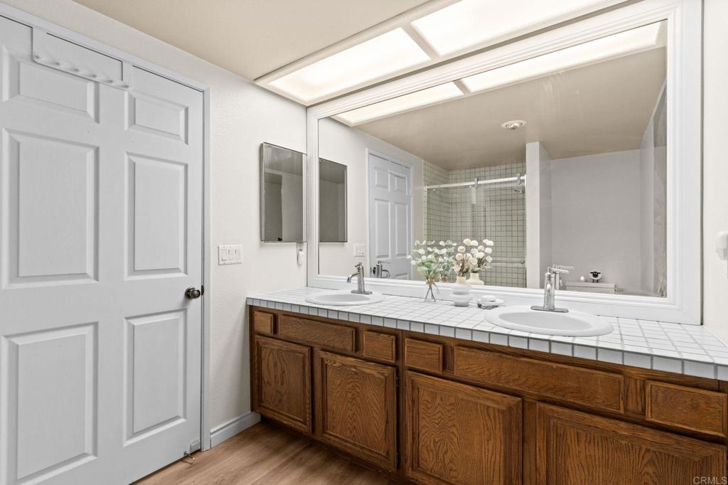 17597 Fairlie Road San Diego, CA 92128 - Photo 8 of 15 a bathroom with a double vanity sink and a mirror
