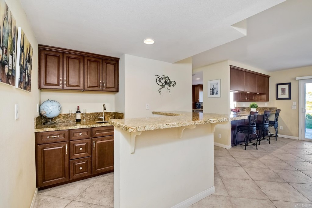2754 Olympia Drive Carlsbad, CA 92010 - Photo 14 of 35 a kitchen with a stove top oven sink and cabinets