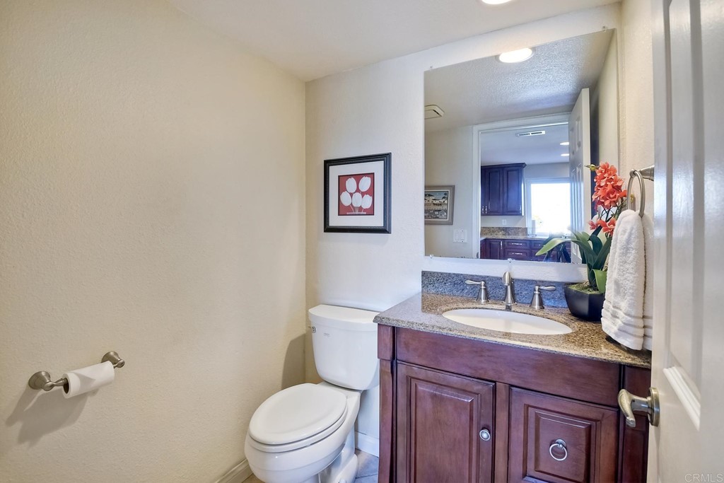 2754 Olympia Drive Carlsbad, CA 92010 - Photo 15 of 35 a bathroom with a toilet a sink and mirror